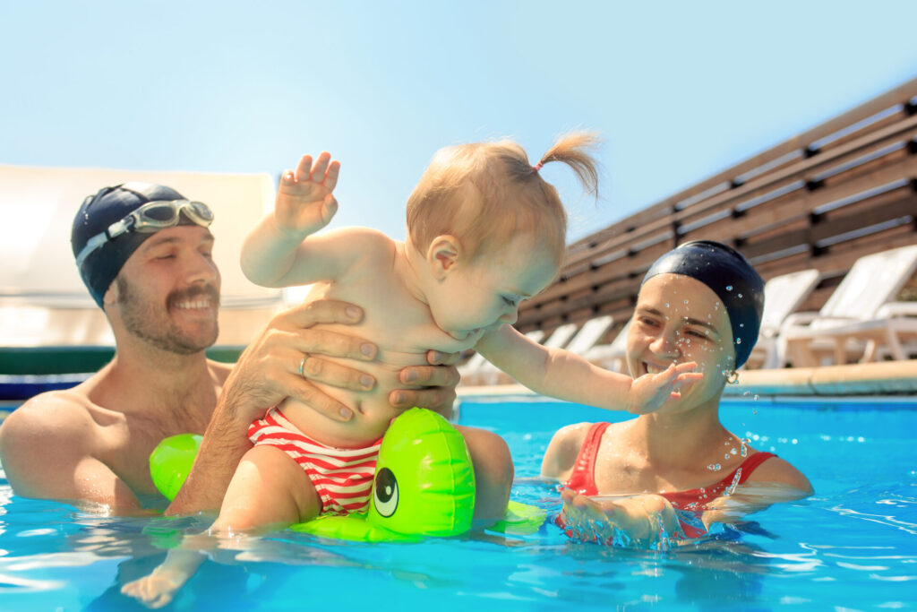 happy family having fun by swimming pool